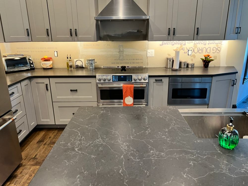 A kitchen with warm under-cabinet lighting along the counters
